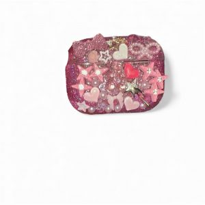 Custom AirPods Pro case with handcrafted embellishments and the AirPods inside.